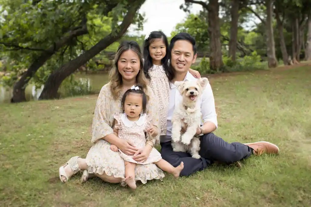 Dr. Hoang outdoors with his wife, two daughters and their dog